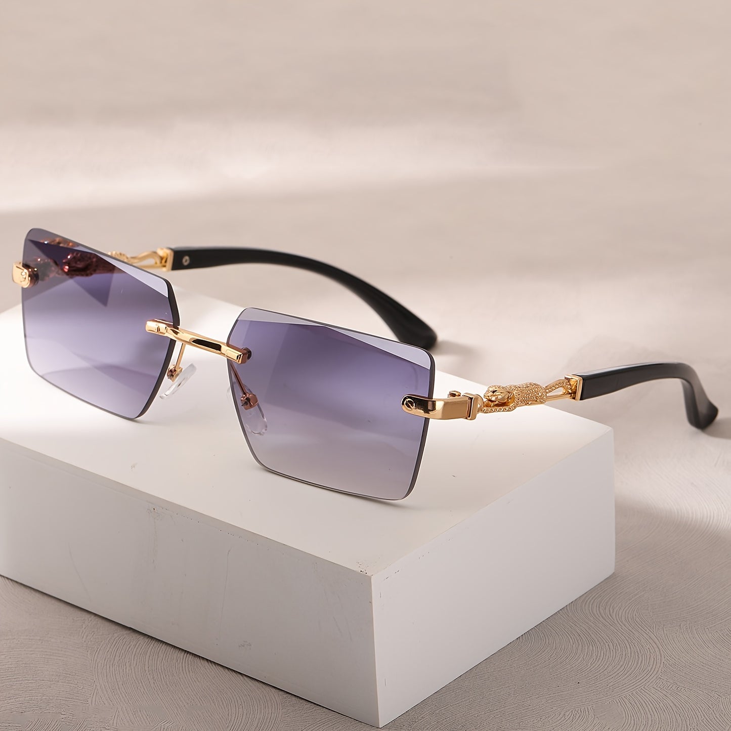 A pair of fashionable glasses with a retro style, featuring rimless leopard print temples and a compact trendy frame