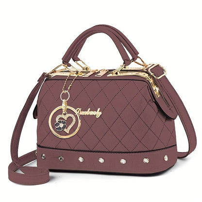Black Quilted Boston Bag with Golden-Tone Hardware & Adjustable Strap - Elegant Heart Rhinestone Charm, Pattern, and Stylish Stud Details for Wo