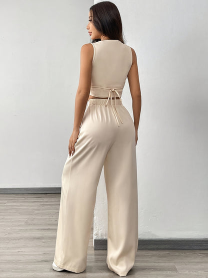 A Set Consisting of Two Women'S Apricot-Colored Sleeveless Cardigans with Square Necklines And Loose-Fitting Wide-Leg Pants.