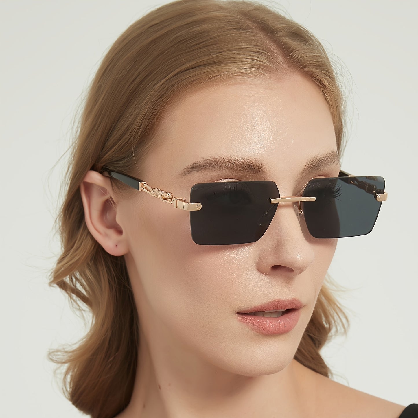 A pair of fashionable glasses with a retro style, featuring rimless leopard print temples and a compact trendy frame