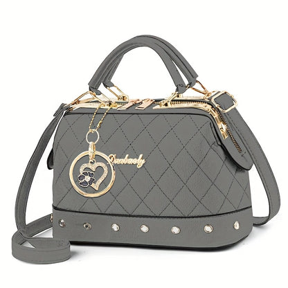 Black Quilted Boston Bag with Golden-Tone Hardware & Adjustable Strap - Elegant Heart Rhinestone Charm, Pattern, and Stylish Stud Details for Wo